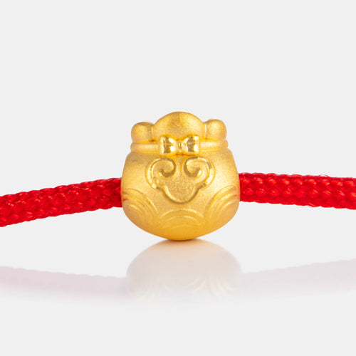 24K Gold Moneybag Charm on a red knot bracelet