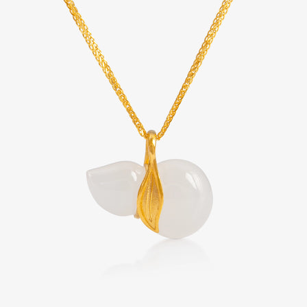  A delicately carved nephrite hulu pendant wrapped in 24K gold, symbolizing good fortune and longevity.