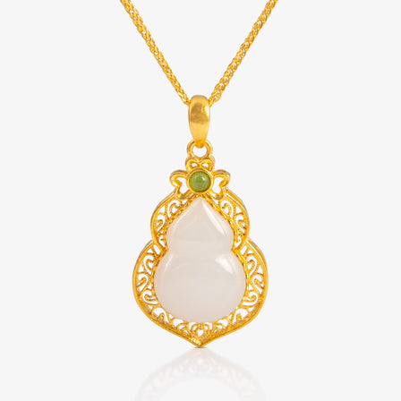 Nephrite and 24K Gold filigree hulu pendant featuring intricate gold detailing with a central nephrite stone, weighing 2.45g.