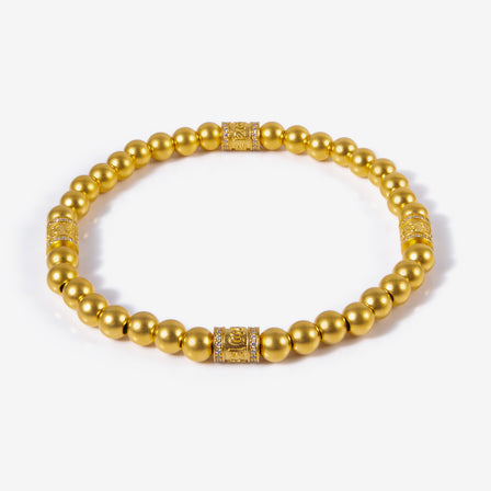 24K gold six-syllable bead bracelet with matte finish and diamond-set charms

Close-up of diamond-set Dharma charm on antique gold bead bracelet