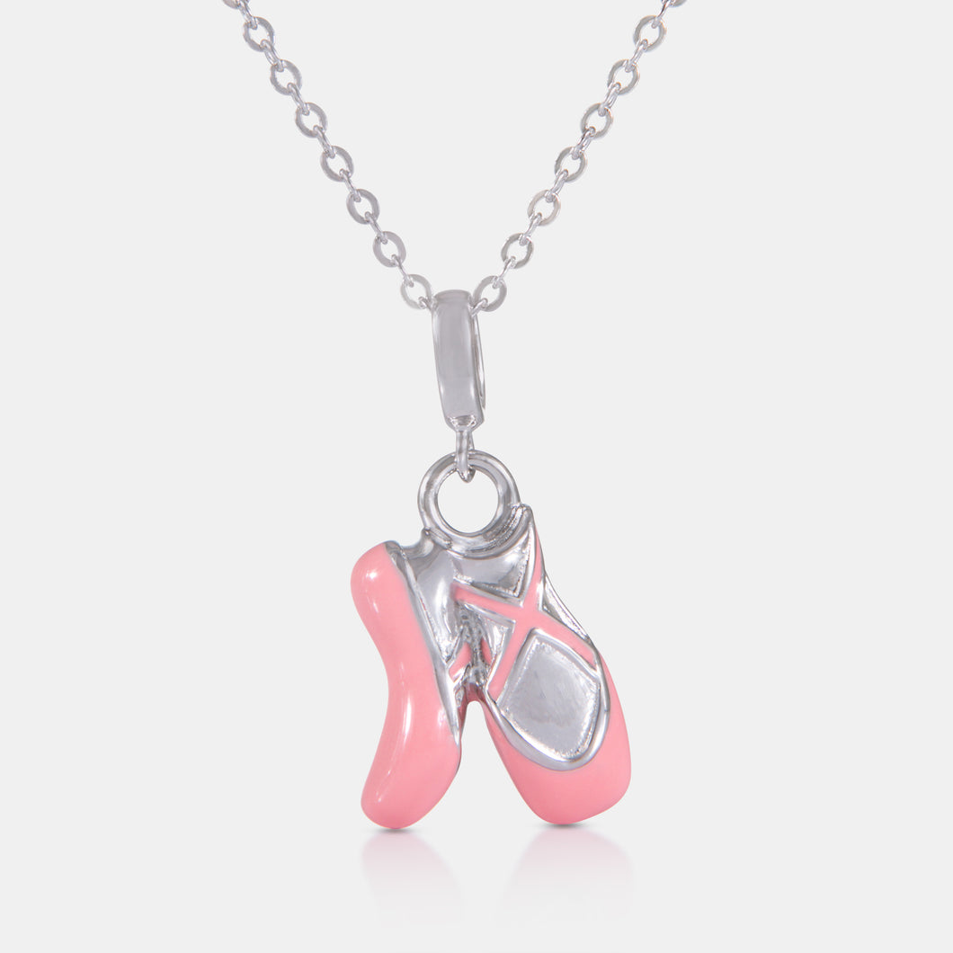 Sterling silver necklace pendant shaped like ballet shoes with soft pink enamel detailing, from the LFX x Goh Collection, inspired by the elegance of ballet and Goh Ballet’s Nutcracker performance.