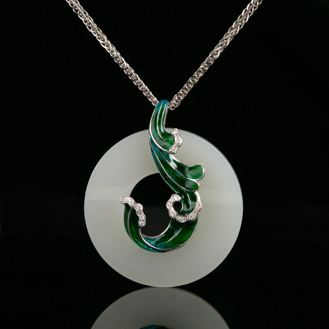 A beautifully designed 18K white gold pendant featuring a hand-carved nephrite jade with enamel detailing and diamonds